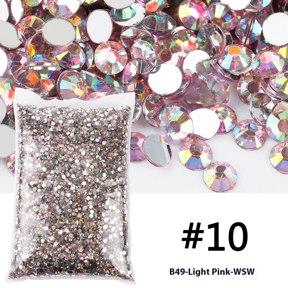 Assortment of multicoloured flat back resin rhinestones in various sizes for nail art and craft projects.