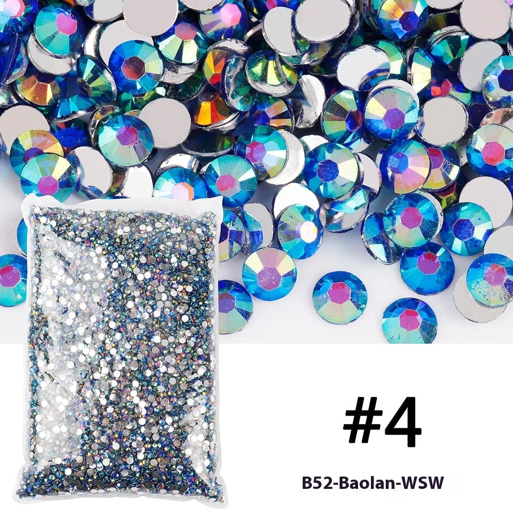 Assortment of multicoloured flat back resin rhinestones in various sizes for nail art and craft projects.