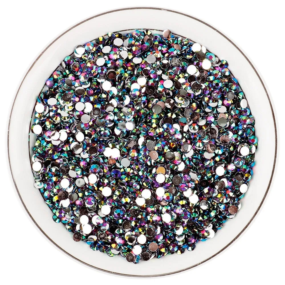 Assortment of multicoloured flat back resin rhinestones in various sizes for nail art and craft projects.