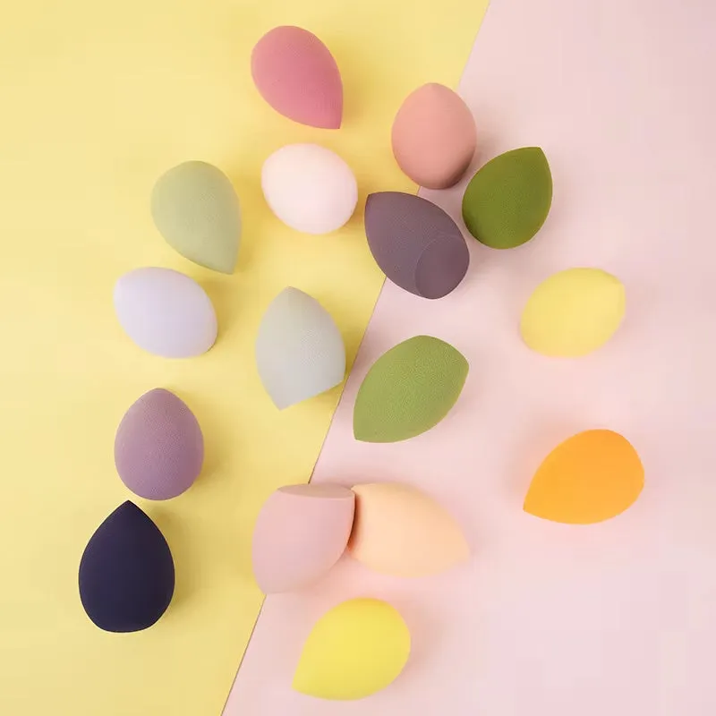 Seven different shaped makeup sponge puffs in various colours including pink, blue and burgundy
