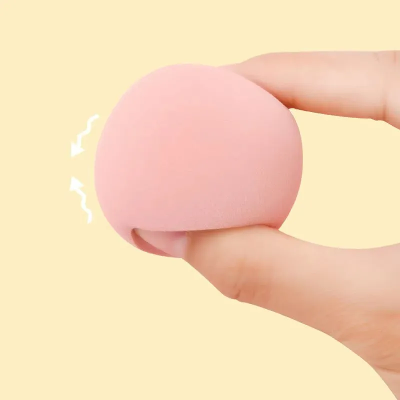 Seven different shaped makeup sponge puffs in various colours including pink, blue and burgundy