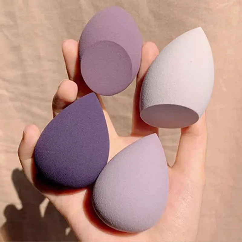 Seven different shaped makeup sponge puffs in various colours including pink, blue and burgundy
