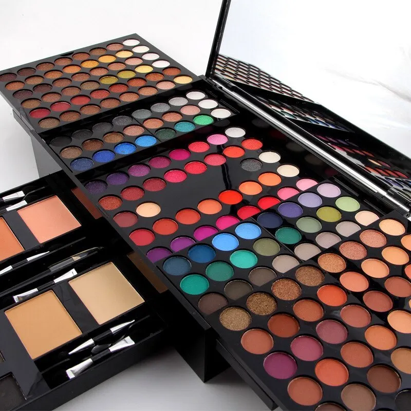 Piano-shaped makeup palette open to show 180 eyeshadows, blushes and powders inside.