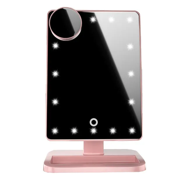 Pink touch screen LED makeup mirror with Bluetooth speaker and magnifying mirror on a table.