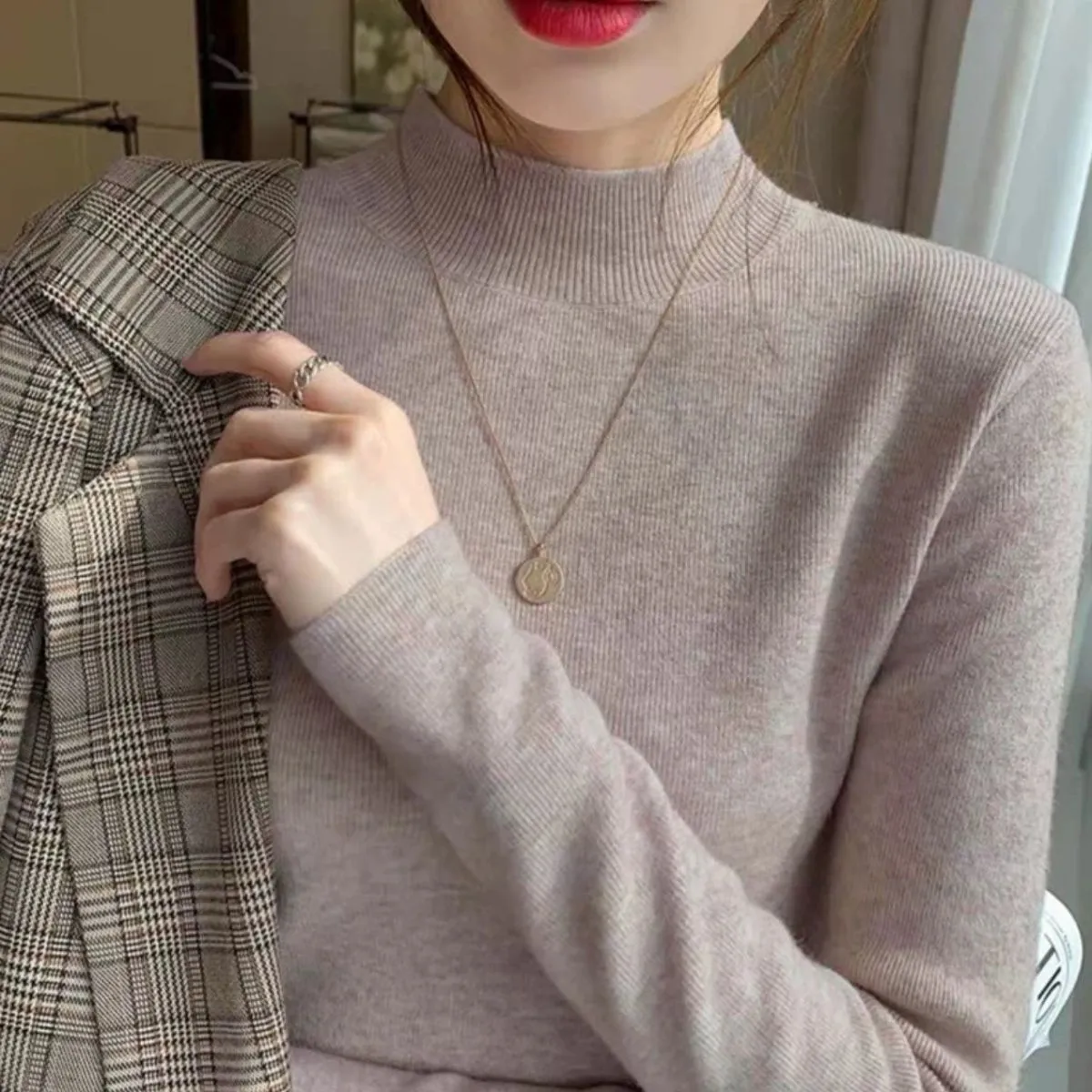 Slim fit long sleeve viscose top in apricot colour on a hanger