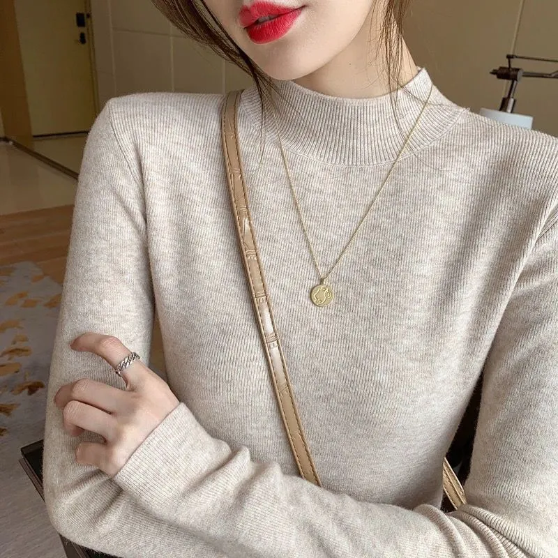 Slim fit long sleeve viscose top in apricot colour on a hanger