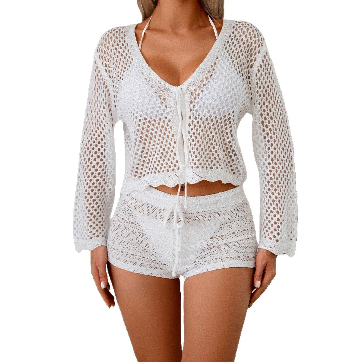 Short apricot hollow woven cardigan blouse with bell sleeves on a hanger.
