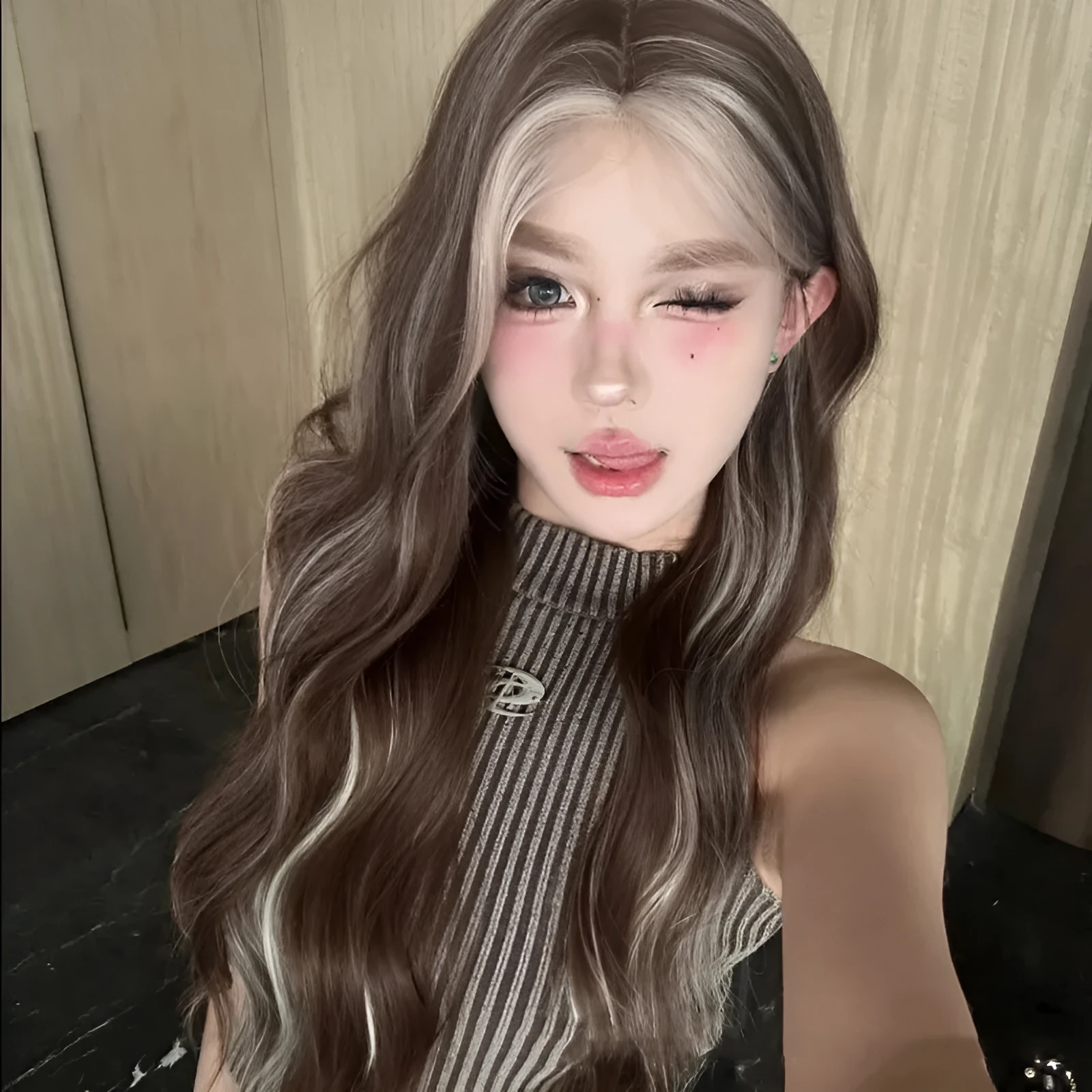 Long curly synthetic wig with grey golden highlights and straight lace front design