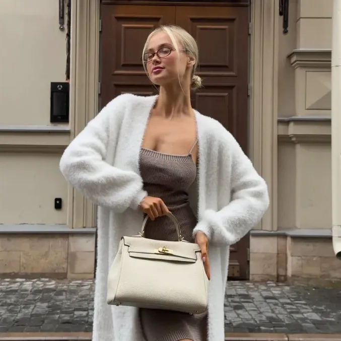 Long white women's cardigan jacket with thick knit and open front.