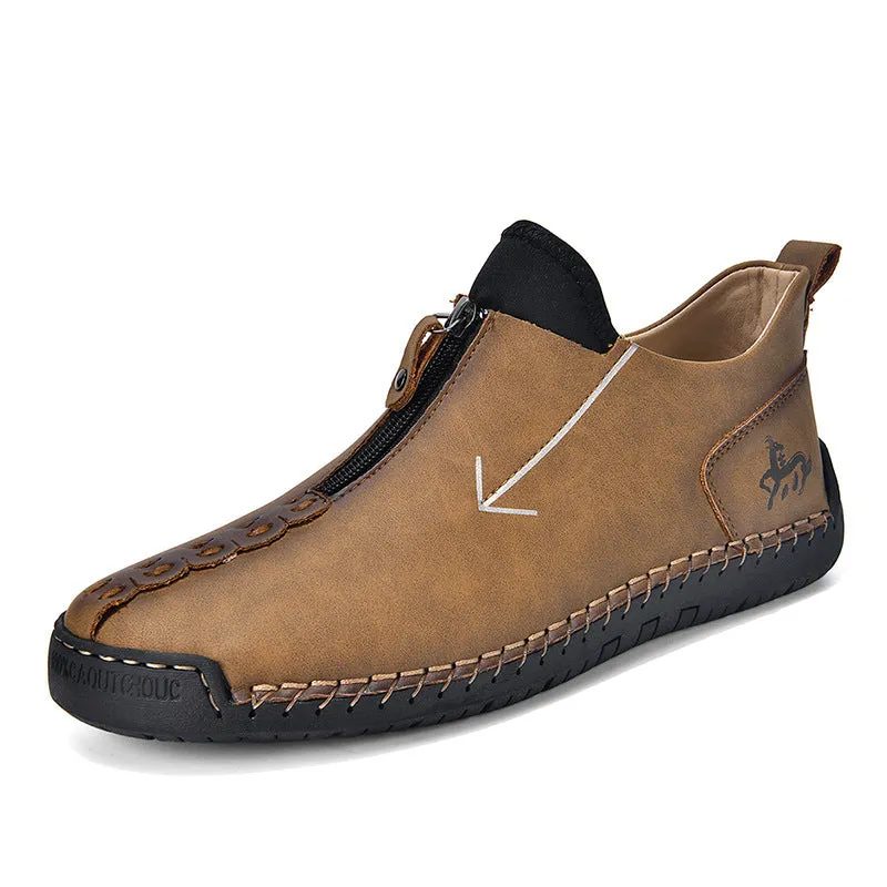 Men's black leather martin boots with a front metal zipper and round toe on a rubber sole.
