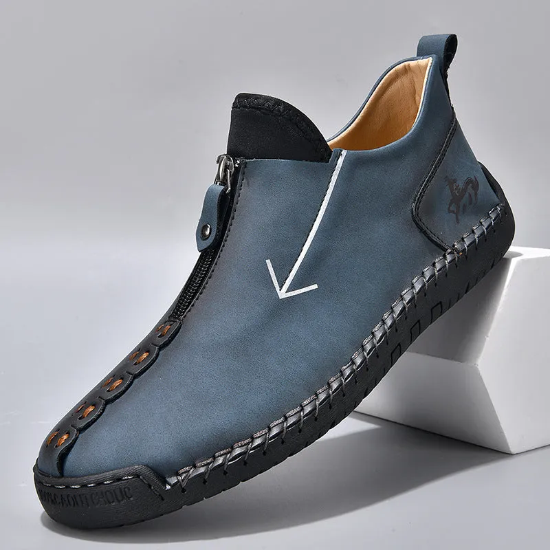 Men's black leather martin boots with a front metal zipper and round toe on a rubber sole.