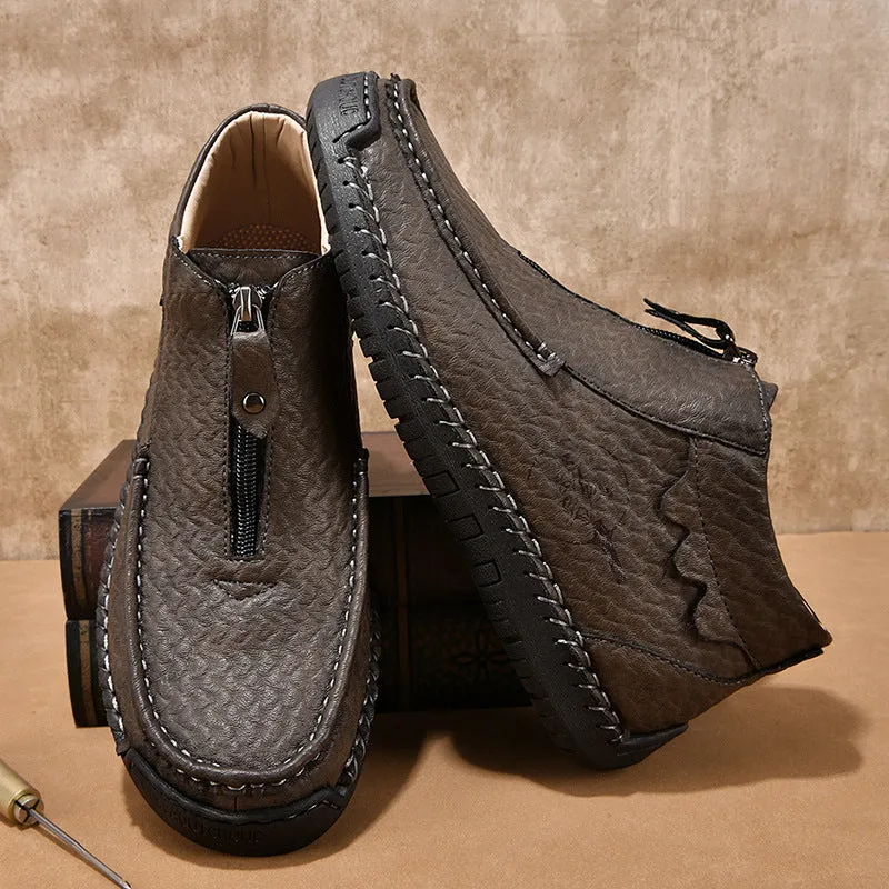 Men's black slip-on loafers with round toe and stitched sole on a plain background