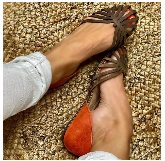 Women's leopard print flat sandals with a square buckle ankle strap on a dark brown background.