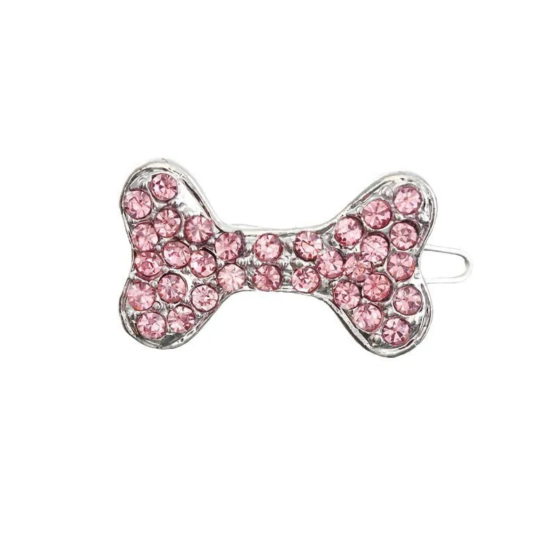 Rhinestone dog bone hair clip in alloy, white colour, on a neutral background