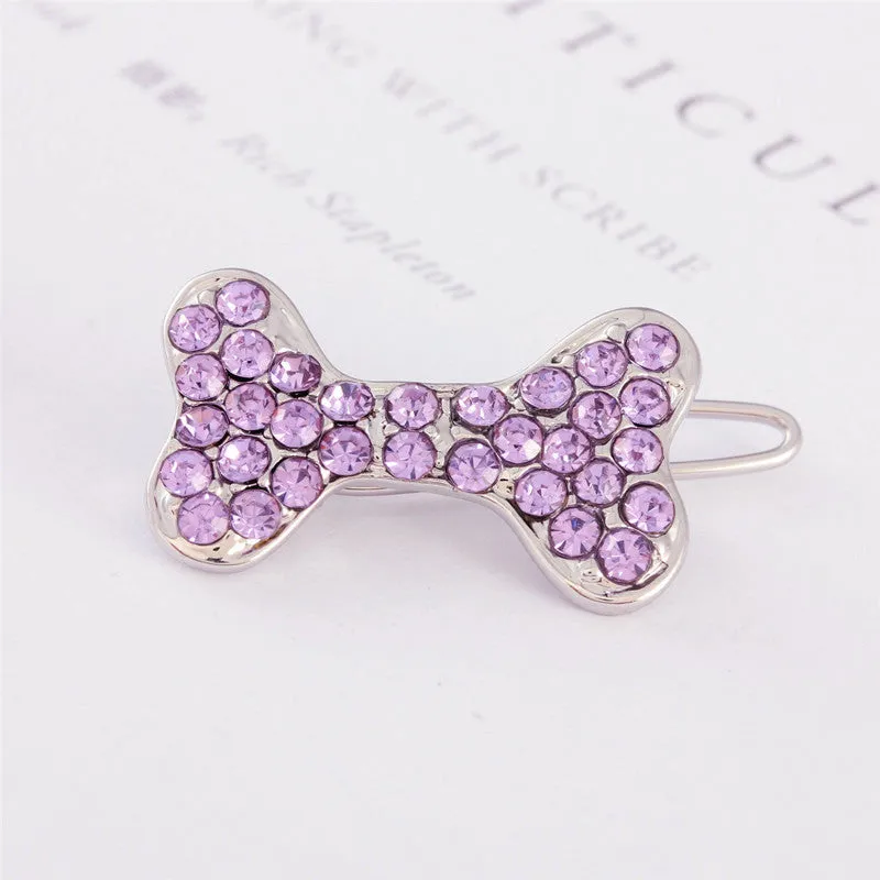 Rhinestone dog bone hair clip in alloy, white colour, on a neutral background