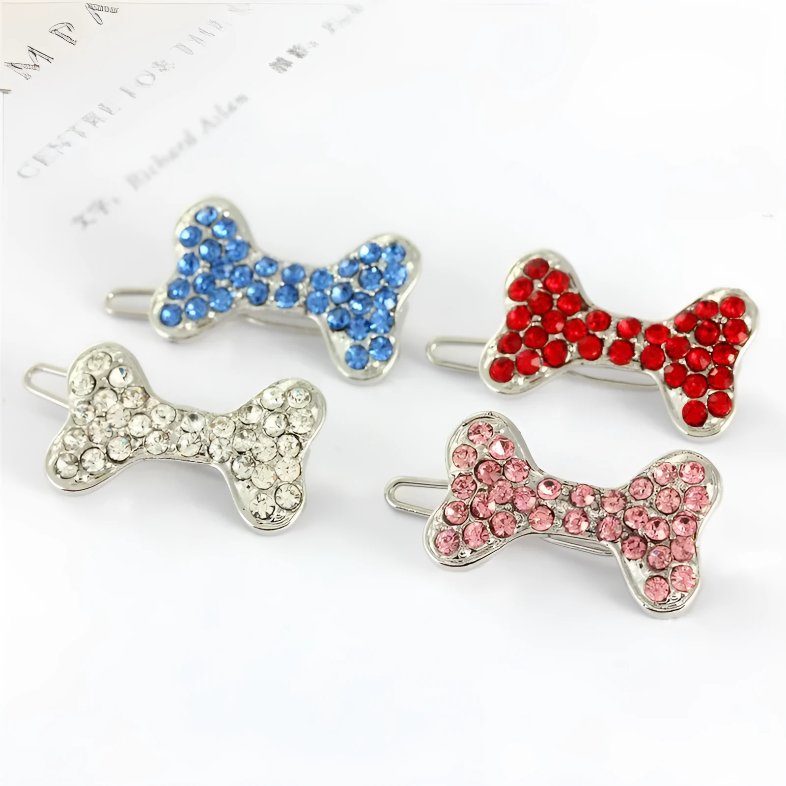 Rhinestone dog bone hair clip in alloy, white colour, on a neutral background