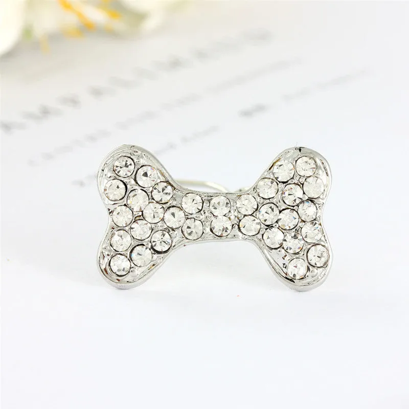 Rhinestone dog bone hair clip in alloy, white colour, on a neutral background