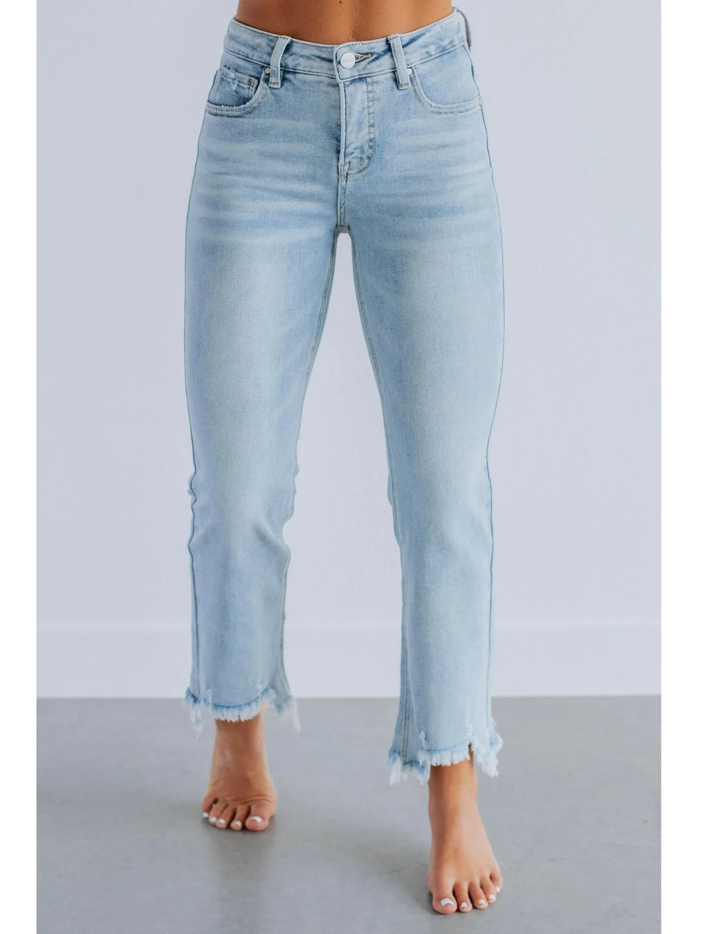Women's solid colour denim jeans in dark blue showing hand-worn texture and casual fit.