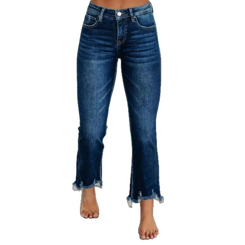 Women's solid colour denim jeans in dark blue showing hand-worn texture and casual fit.