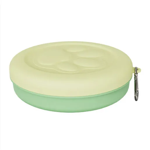 Collapsible two-layer silicone dog travel bowl in light pink and green, showing food and water compartments.