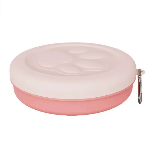 Collapsible two-layer silicone dog travel bowl in light pink and green, showing food and water compartments.