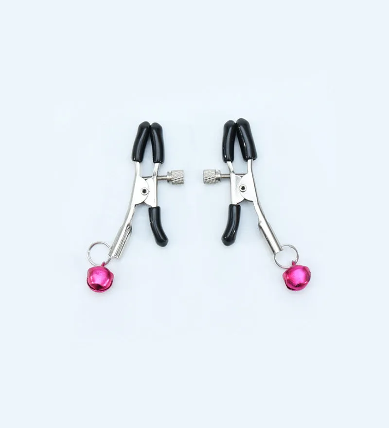 Red bell nipple clamp pair with chain attachment on a dark background