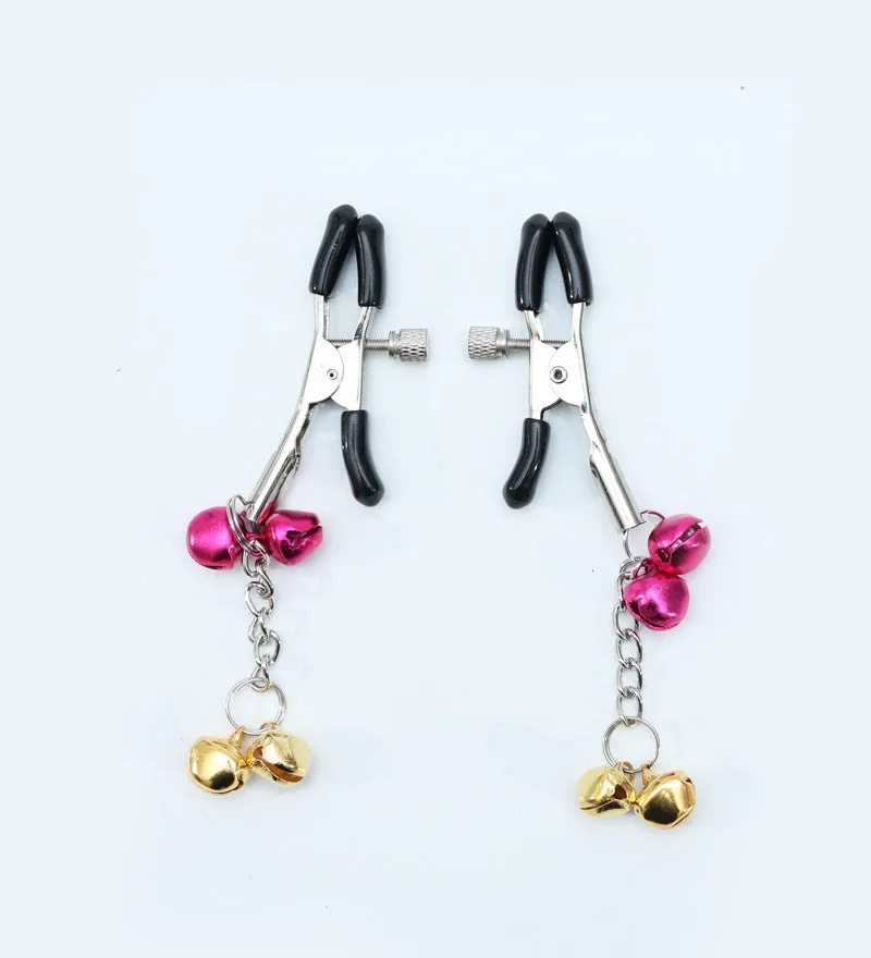 Red bell nipple clamp pair with chain attachment on a dark background