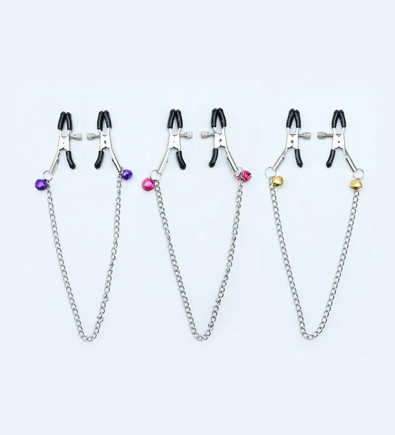 Red bell nipple clamp pair with chain attachment on a dark background