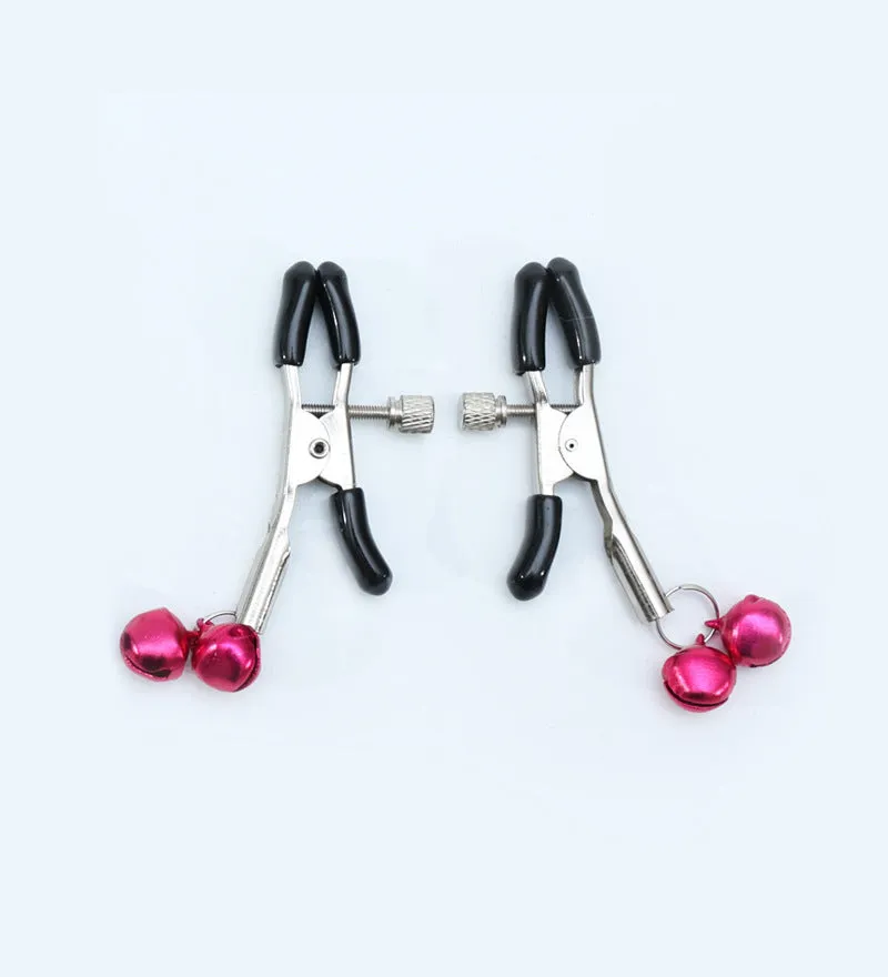 Red bell nipple clamp pair with chain attachment on a dark background