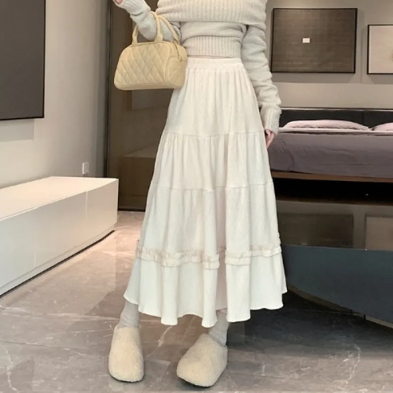 Beige corduroy A-line midi skirt with elastic waistband on a hanger.
