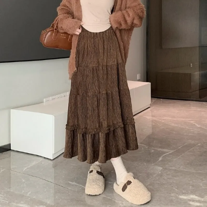 Beige corduroy A-line midi skirt with elastic waistband on a hanger.