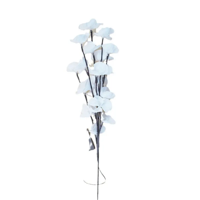 Pink Phalaenopsis-shaped LED decorative light with a bendable 65cm fabric branch on a wooden table.
