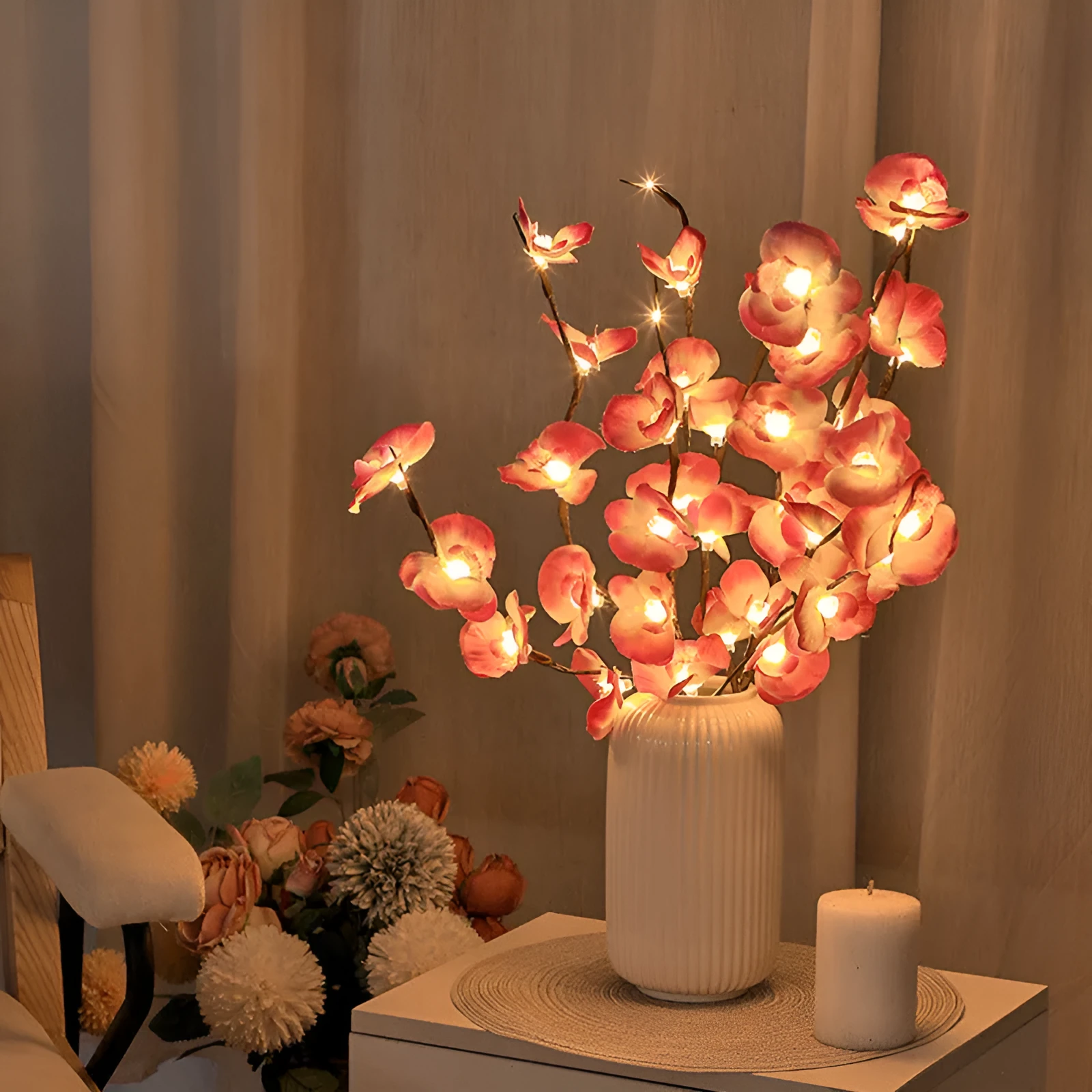 Pink Phalaenopsis-shaped LED decorative light with a bendable 65cm fabric branch on a wooden table.