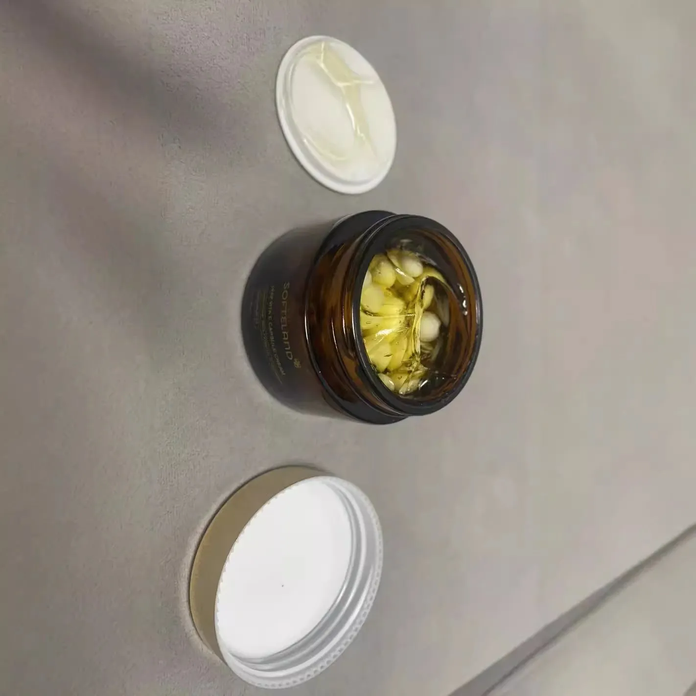 Vitamin C facial capsule 55g in container with small spoon for application
