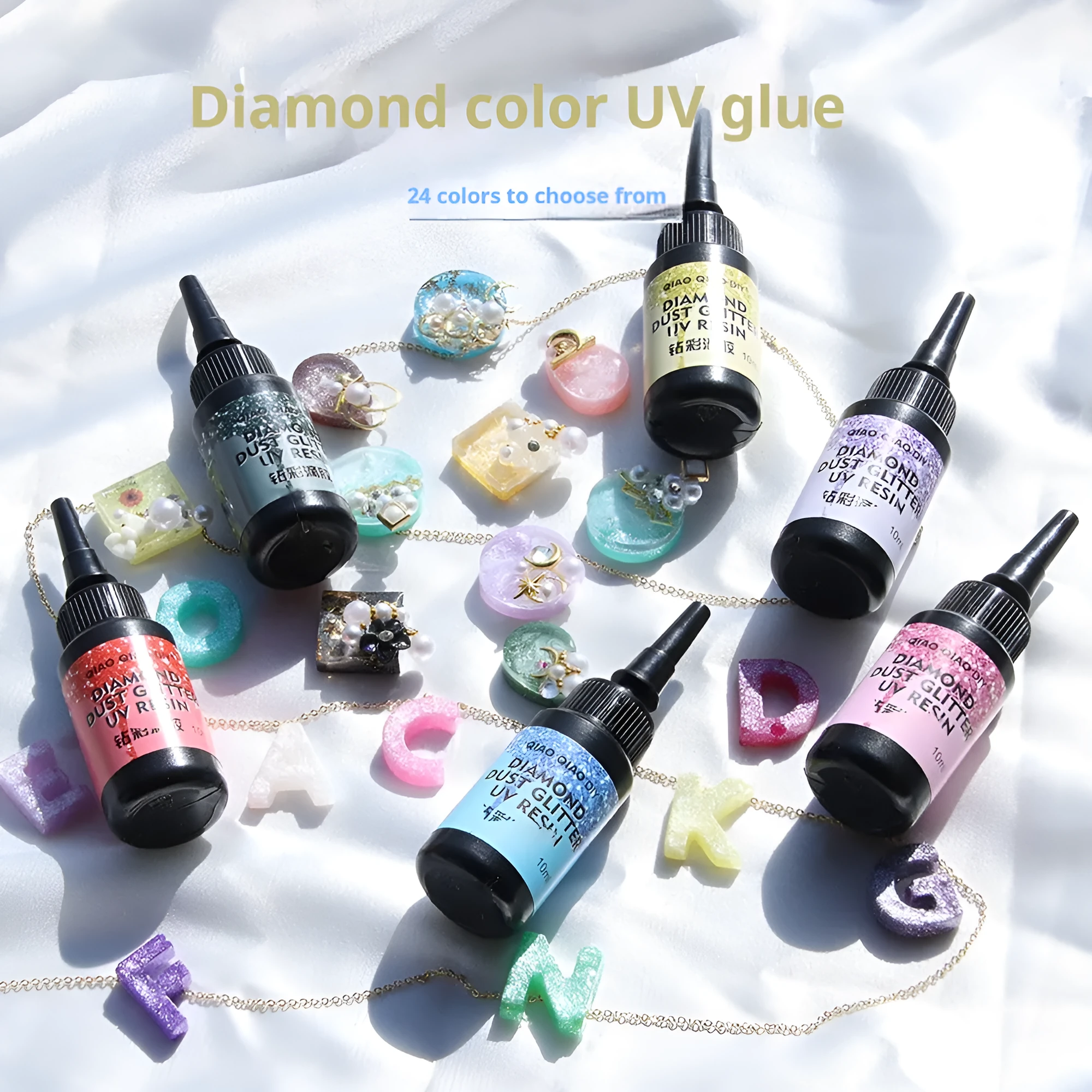 UV epoxy diamond 24 colour set with gold, silver, blue, pink, and green sequins on a white surface