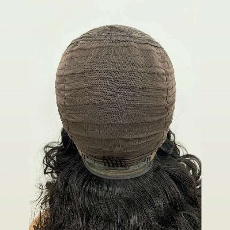 Ombre curly human hair lace wig in black with oblique bangs on a mannequin head