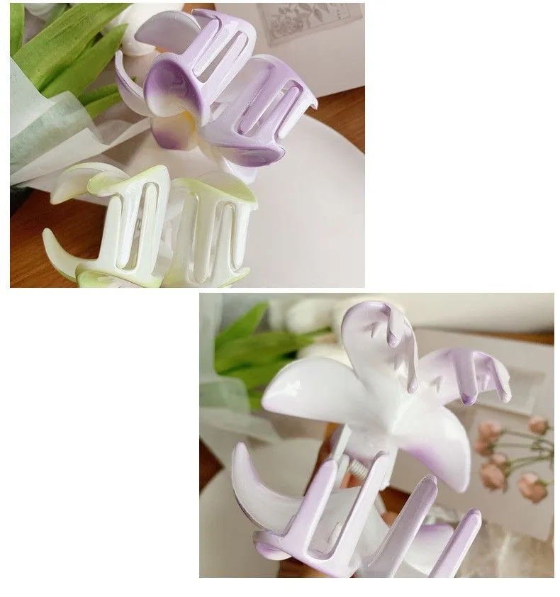 Muweordy plumeria hair claw clip in blue, a decorative flower hair accessory made from plastic and resin.