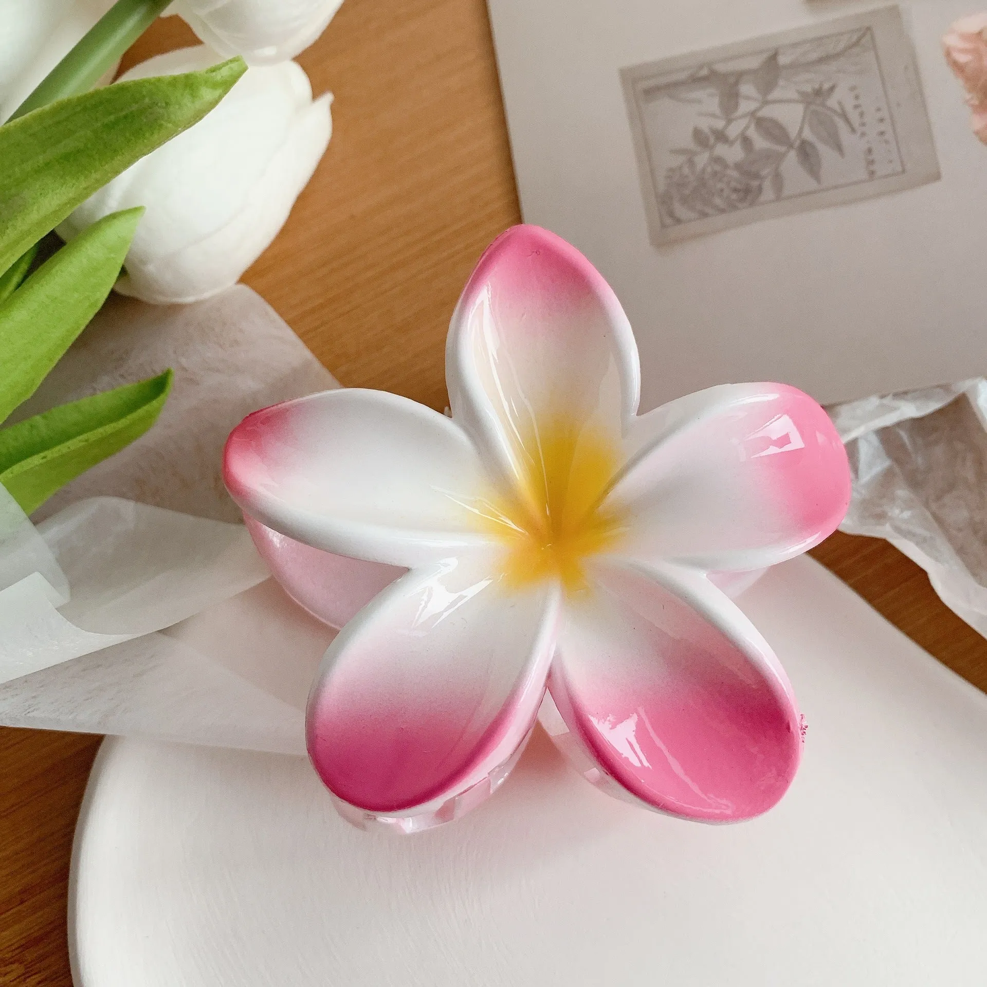 Muweordy plumeria hair claw clip in blue, a decorative flower hair accessory made from plastic and resin.