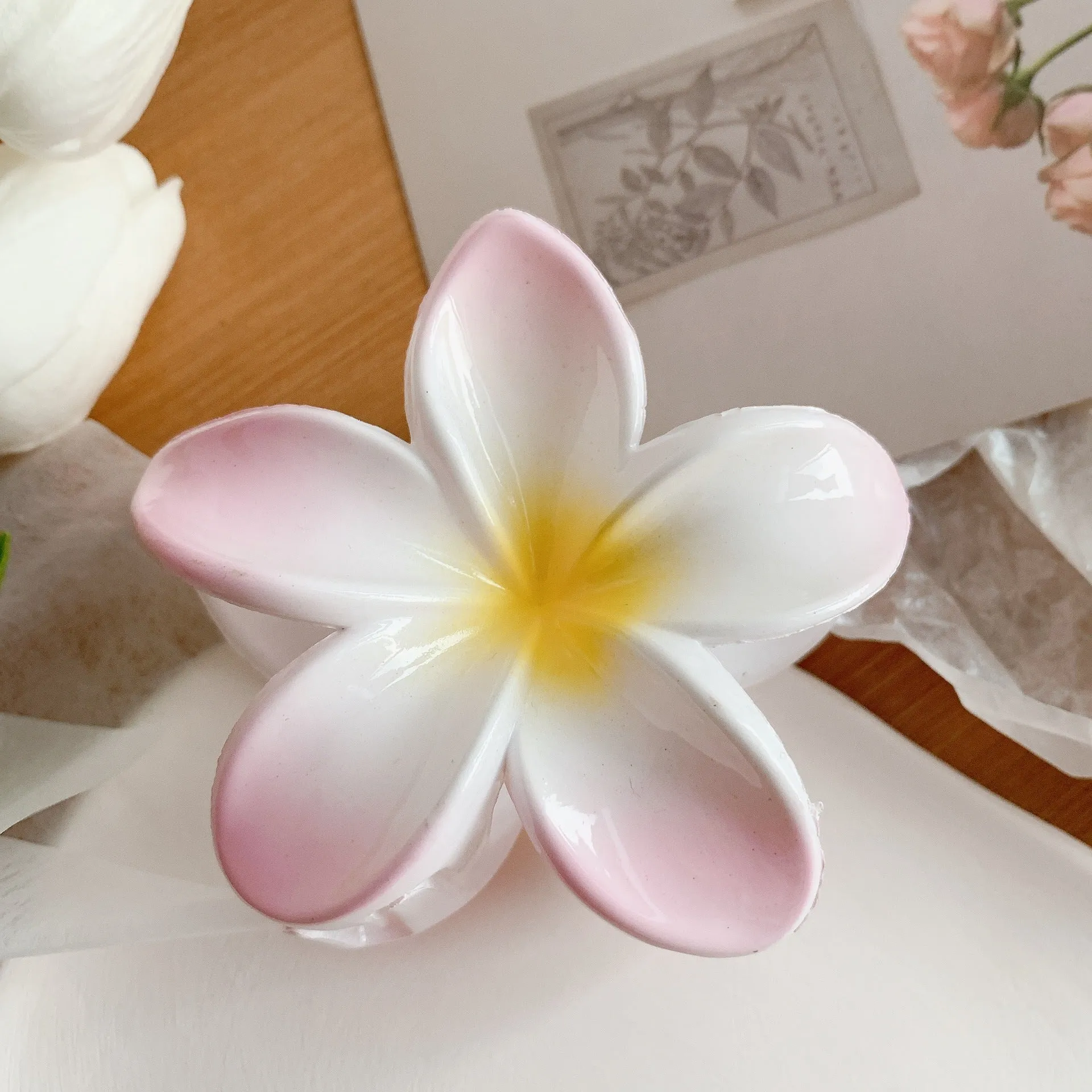 Muweordy plumeria hair claw clip in blue, a decorative flower hair accessory made from plastic and resin.