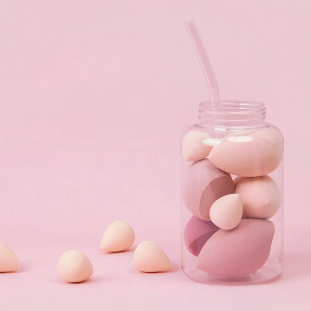 Set of 7 makeup sponge eggs in various colours inside transparent jar with multiple cut shapes
