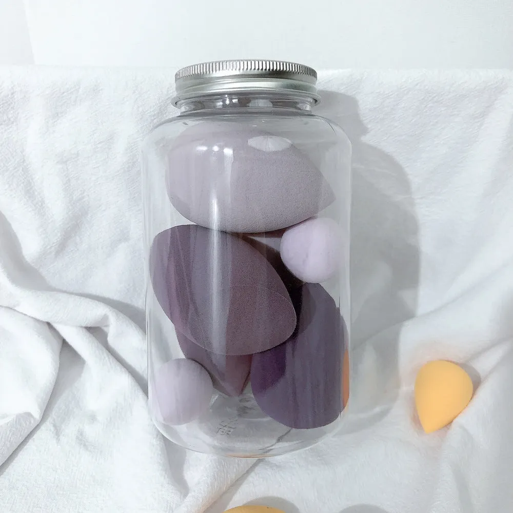 Set of 7 makeup sponge eggs in various colours inside transparent jar with multiple cut shapes