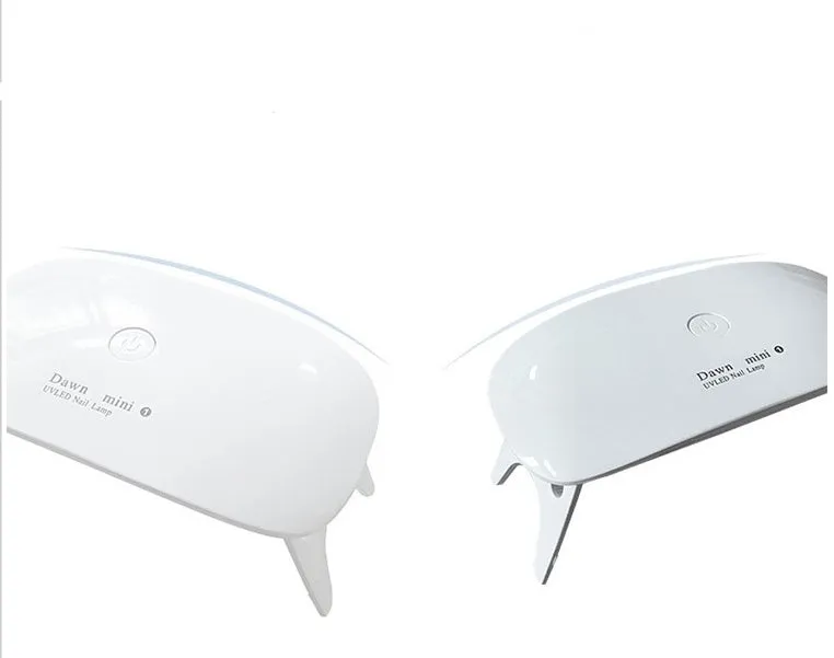 Portable nail dryer in white colour with phototherapy lamp and sealing function on a table