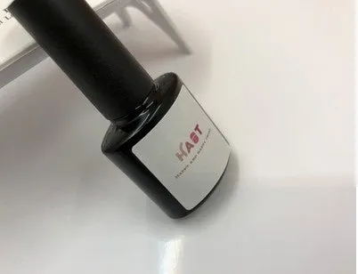 Portable nail dryer in white colour with phototherapy lamp and sealing function on a table