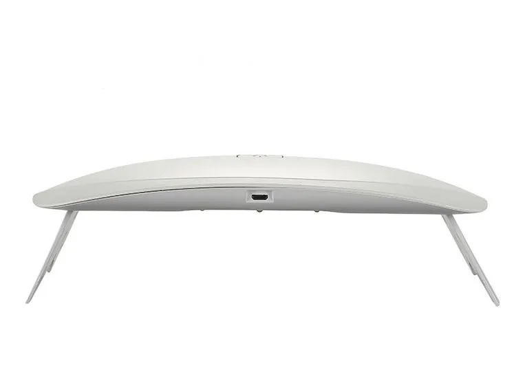 Portable nail dryer in white colour with phototherapy lamp and sealing function on a table