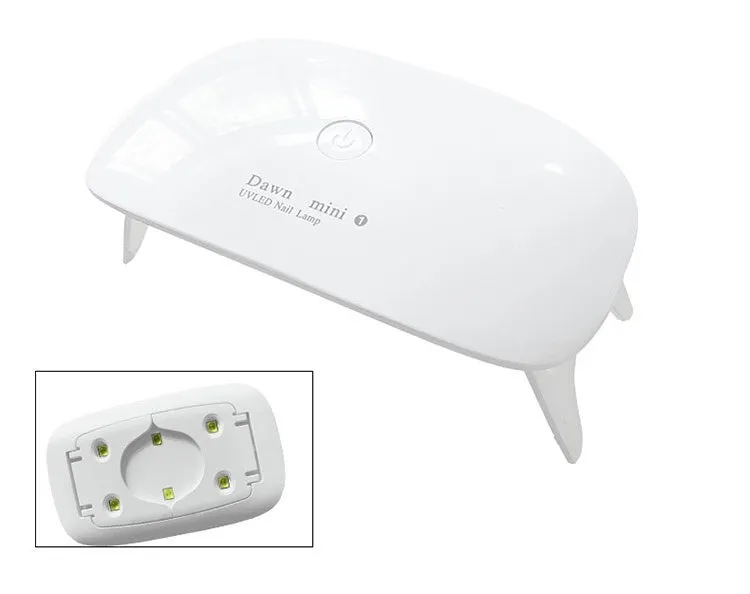 Portable nail dryer in white colour with phototherapy lamp and sealing function on a table