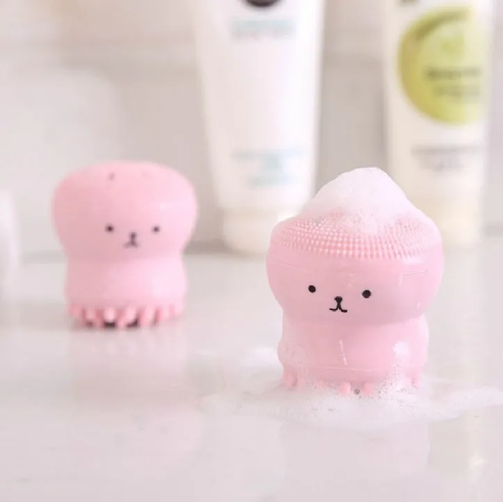 Cartoon octopus silicone wash brush in pink for manual facial cleansing and massage