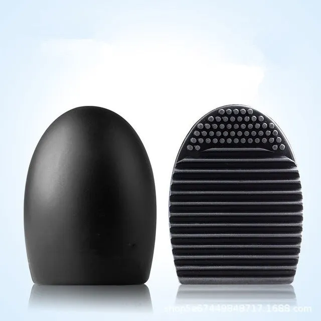 Silicone makeup brush wash egg in blue with top knobs and bottom grooves for cleaning bristles