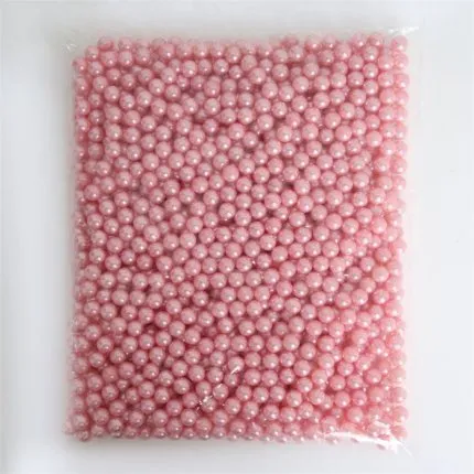 Clear acrylic makeup brush holder on a countertop with pearl coloured beads inside, measuring 12.3x10.6x21.5cm