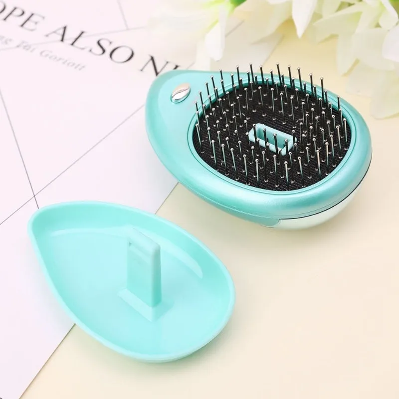 Pink electric sound wave vibration magnetic massage comb with ergonomic handle and negative ion function
