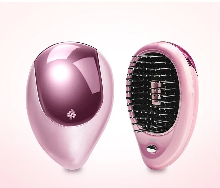 Pink electric sound wave vibration magnetic massage comb with ergonomic handle and negative ion function